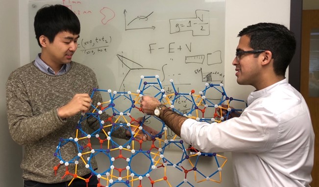 Shahani (right) and graduate student Insung Han (left) discuss cluster attachments on an atomic model of a 2D decagonal quasicrystal.   Shahani (right) and graduate student Insung Han (left) discuss cluster attachments on an atomic model of a 2D decagonal quasicrystal.